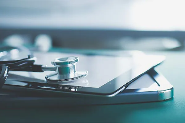 Advanced-Diagnostic-Testing-Clinic Close up of a stethoscope lying on a tablet, representing advanced functional medicine testing offered by Optimal Wellness Medical Group in Grand Rapids.