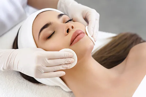custom-facials-grand-rapids Close up of a relaxing woman with smooth skin receiving a facial. Optimal Wellness Medical Group offers personalized facials in Grand Rapids.