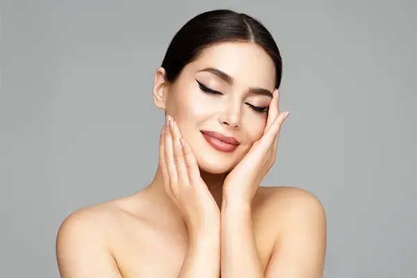 grand-rapids-permanent-makeup-2 Close up of a woman framing her face with her hands, representing permanent makeup treatment by Optimal Wellness Medical Group in Grand Rapids.