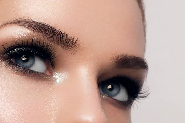 lash-extensions-grand-rapids Close up of a woman's blue eyes with thick, long lashes. Receive lash extensions by Optimal Wellness Medical Group in Grand Rapids.