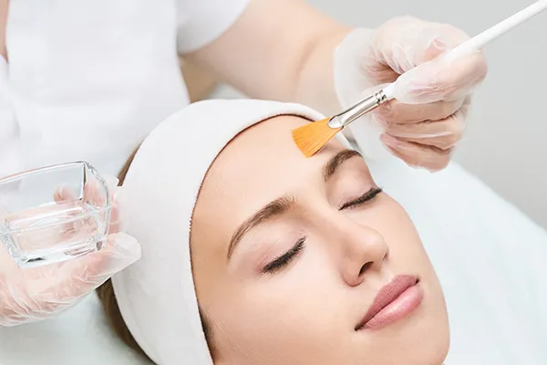 swich-dermal-grand-rapids Close up of a woman relaxing while receiving a facial. Schedule a SWiCH Dermal Rejuvenation consultation with Optimal Wellness Medical Group in Grand Rapids.